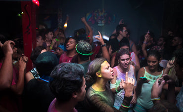 Energetic Dance Party: 25-30 People Having a Blast in a Dimly Lit Room