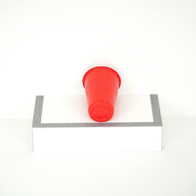 Single red beer pong cup, 16 oz capacity, back view, showcasing rear design 